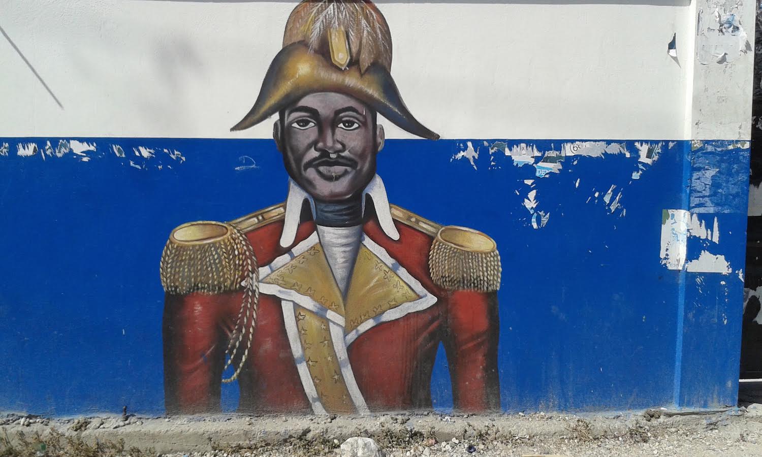 Mural of Dessalines over a white and blue background.