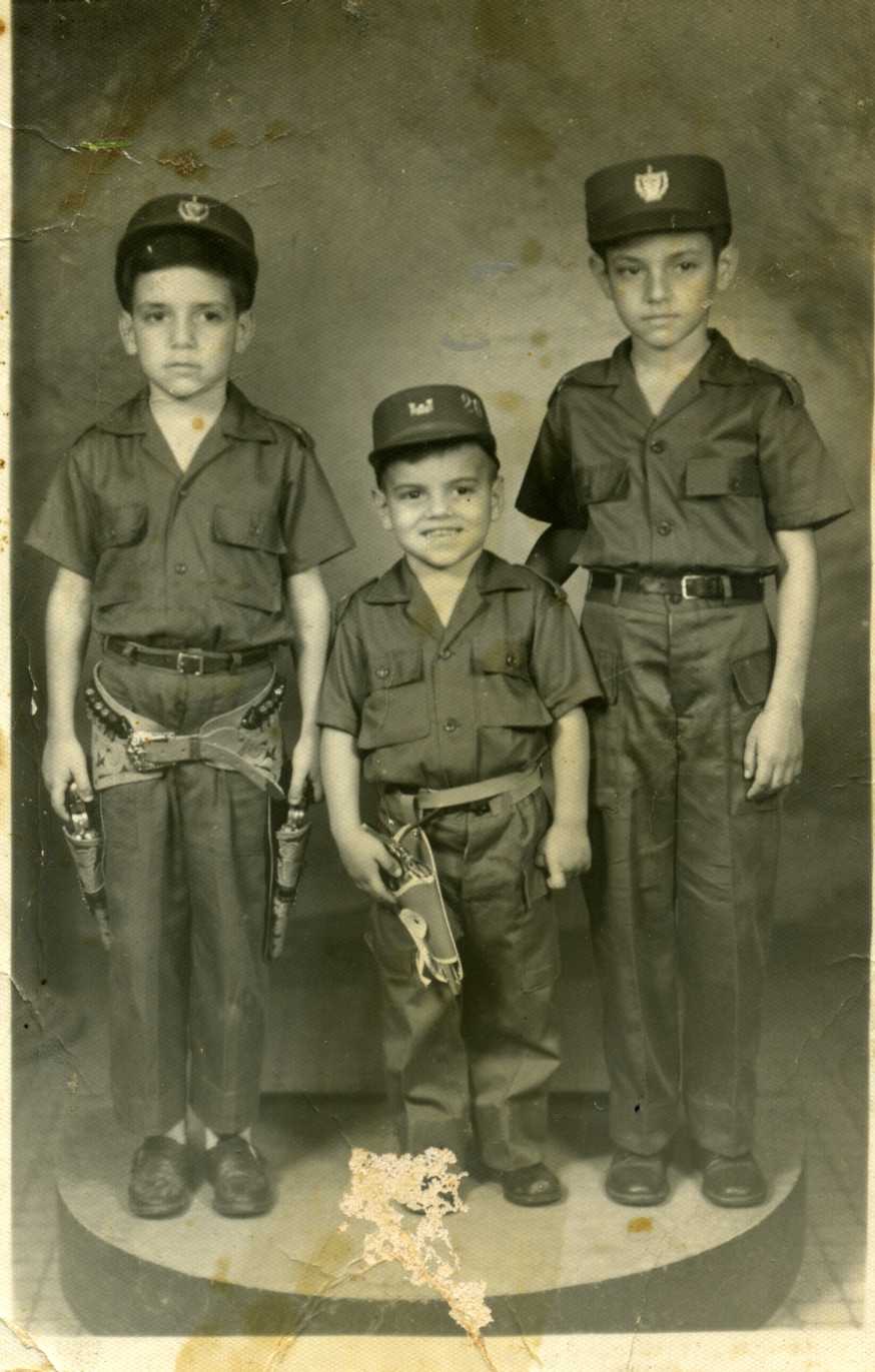Photograph of Jorge, Tony, and Enrique Ermus wearing uniforms.