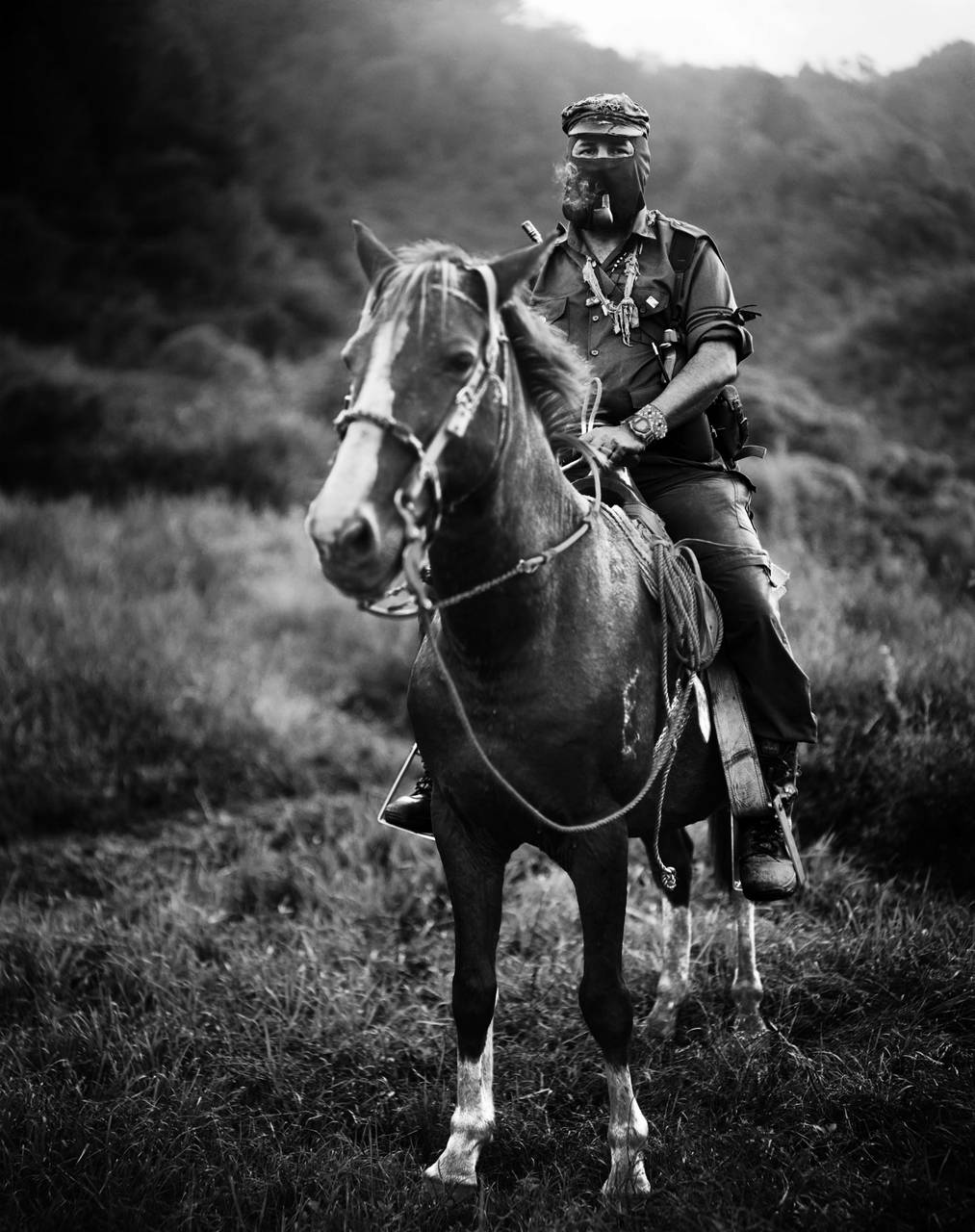 Photograph of a man riding a horse. 