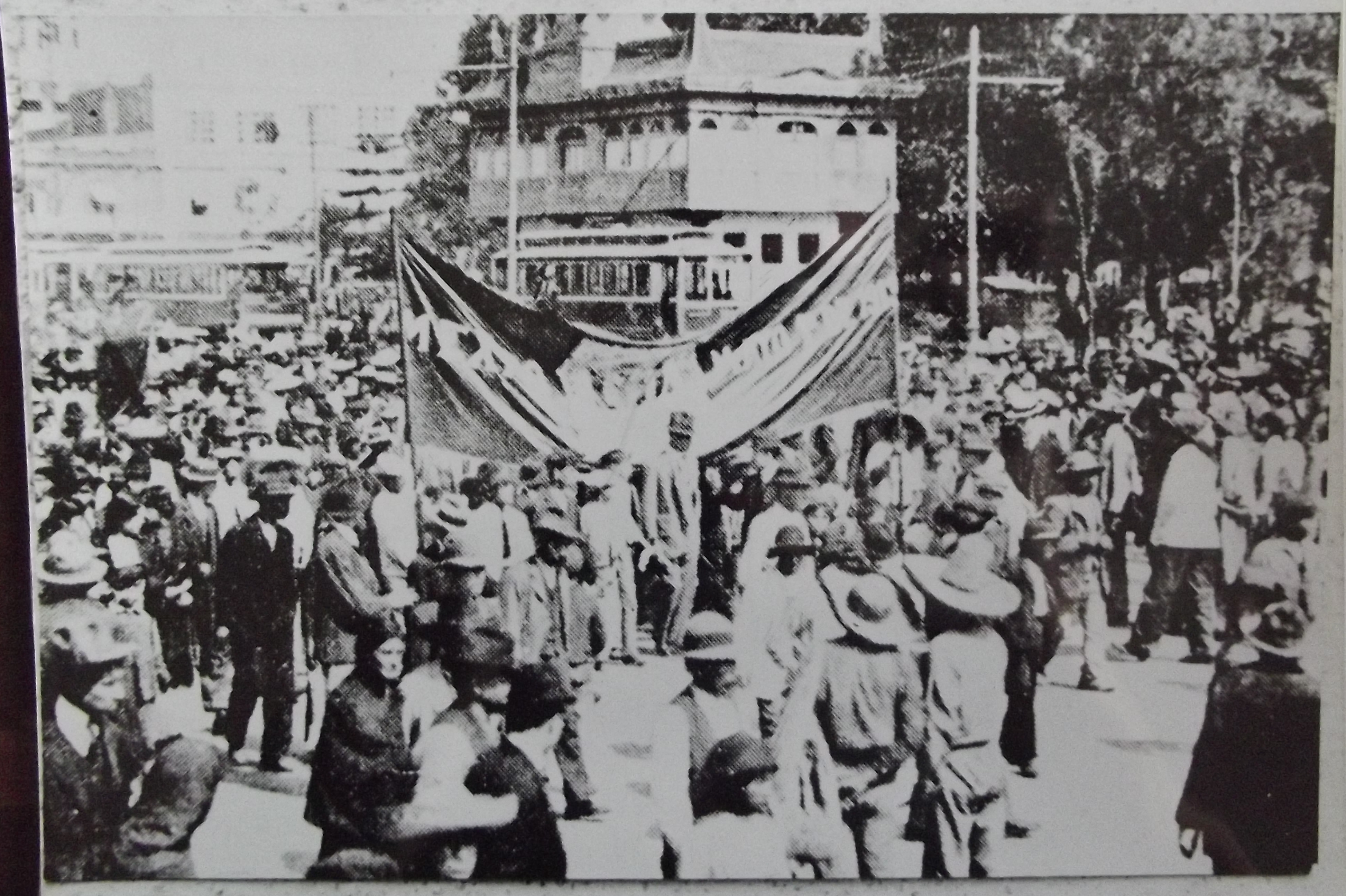 Crowd of workers in the streets with banners.