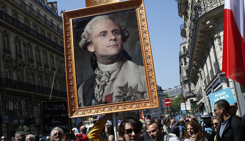 A protest sign with Emmanuel Macron's face on Louis XVI's body. 