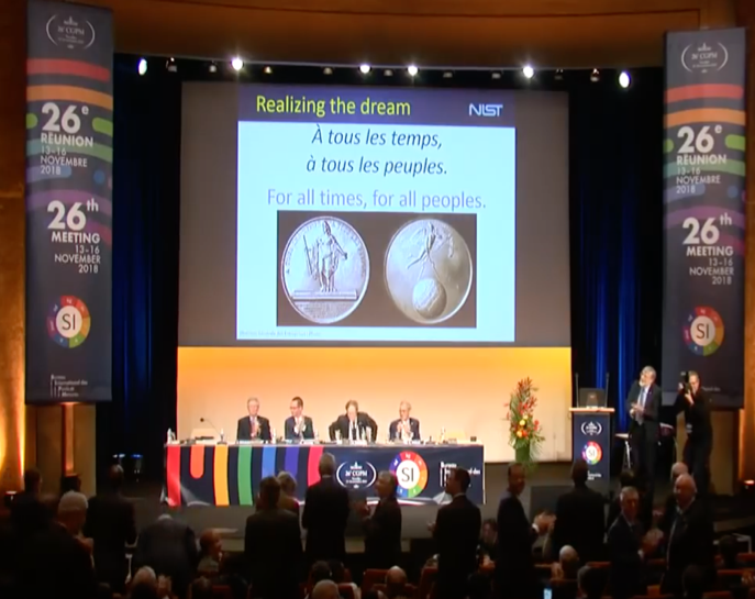 A panel of specialists sitting in front of an audience for a lecture. 