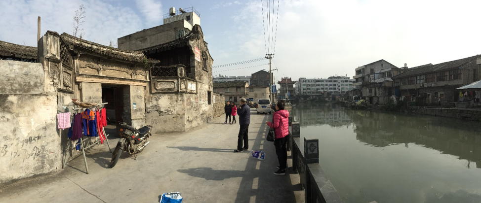 Zhang Gang's village featuring houses and a river. 