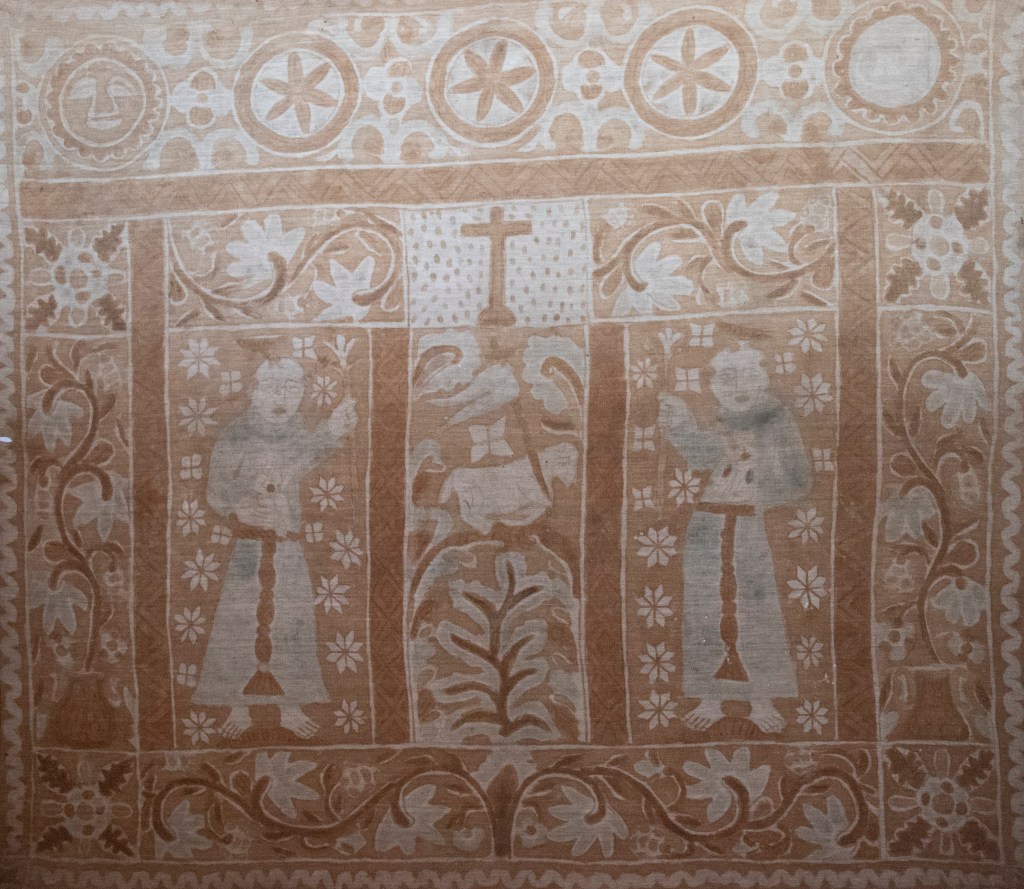 Cloth with Friars and Lamb of God, Museo Comunitario Jalca Grande, La Jalca, Peru, 18th century. Plant-based dyes on cotton. 161 x 190 cm. Photograph by the author.