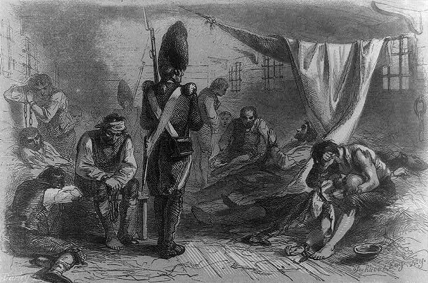 A British soldier guards prisoners of war in the hull of the HMS Jersey